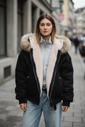 Black fur-collar hooded puffer jacket, front view on model