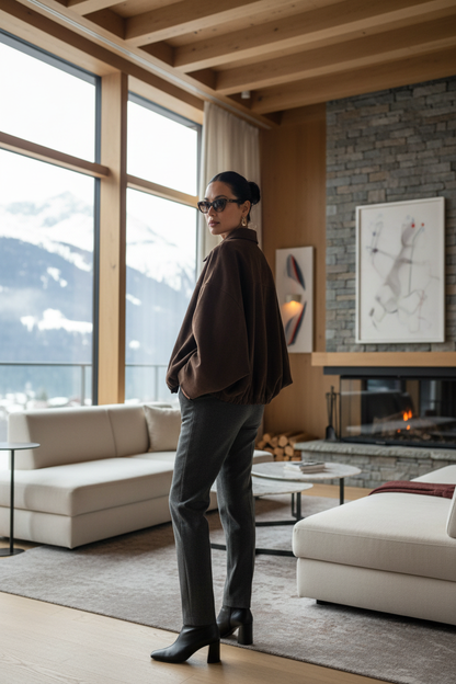 Native Swiss woman showing the deep coffee-brown oversized jacket in a Swiss alpine hotel