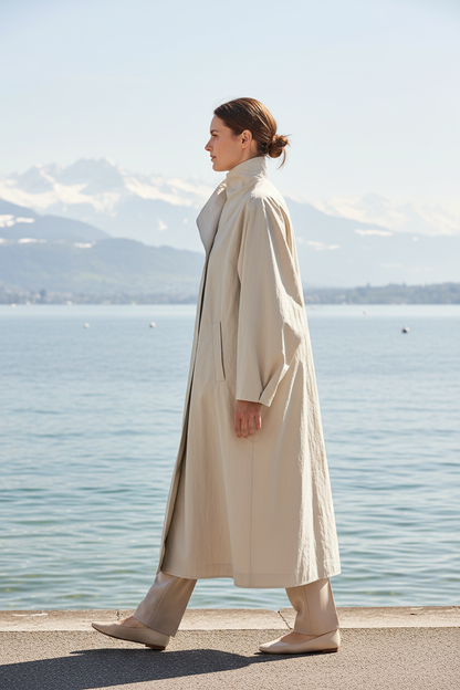 Swiss woman model wearing the pale cream-beige asymmetric convertible-collar coat by Lake Zurich