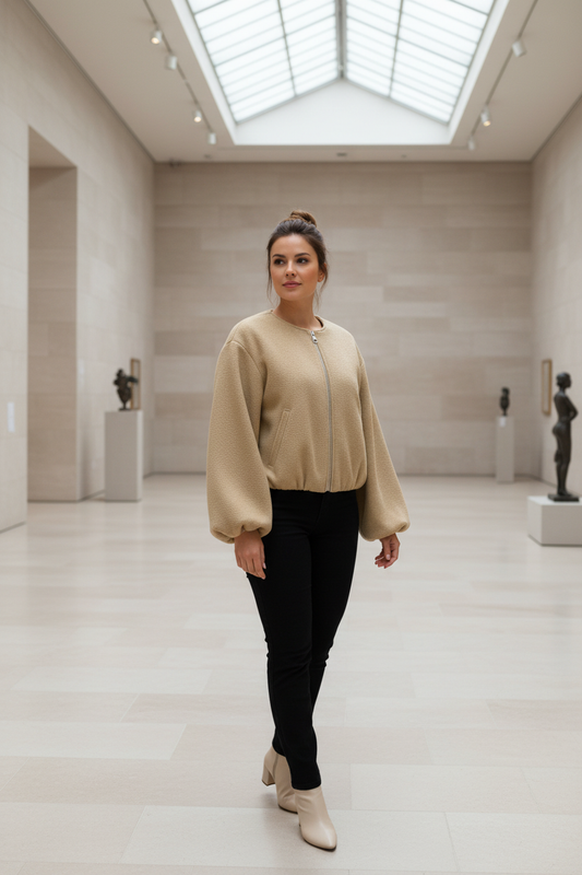 Swiss woman model wearing the khaki fleece cropped bomber jacket in an art gallery