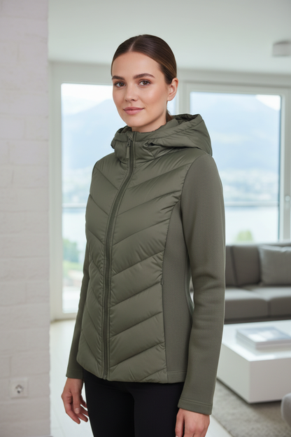 Native Swiss woman wearing the green hooded hybrid jacket in Lucerne